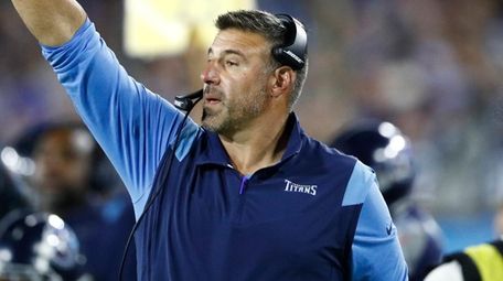 Titans head coach Mike Vrabel signals to his