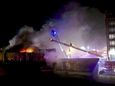 Firefighters use ladder trucks Friday evening to battle