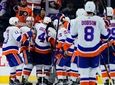 Islanders players celebrate after winning an NHL game