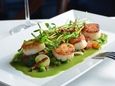 Sea scallops with prosciutto and spring vegetables at