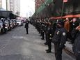 Members of the NYPD salute outside the NYC