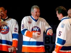 Clark Gillies, second from left, greets Denis Potvin,