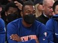 Knicks guard Kemba Walker, center, looks on from