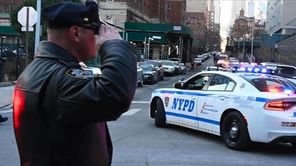 An officer salutes the ambulance carrying the fallen