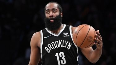 Nets guard James Harden controls the ball against