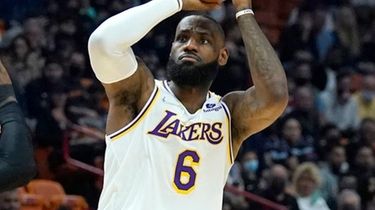 Lakers forward LeBron James attempts a three-point basket