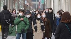 People wearing face masks to protect against the