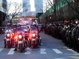 An ambulance carries the body of slain NYPD