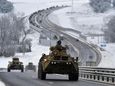 Russian armored vehicles move along a highway in