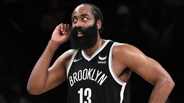 Nets guard James Harden looks on in the