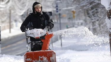 Benjamin Lewis, of Port Jefferson, clears snow from