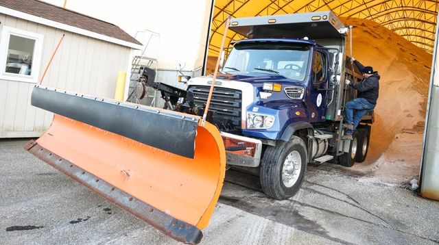 A snow plow truck sits ready to respond