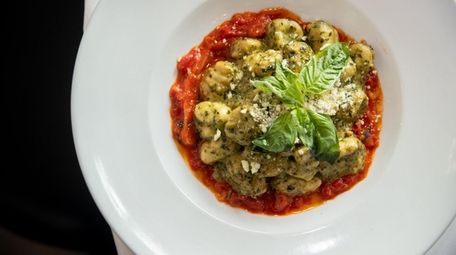 Gnocchi tossed in pesto on a bed of