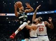 The Bucks' Giannis Antetokounmpo is fouled by the
