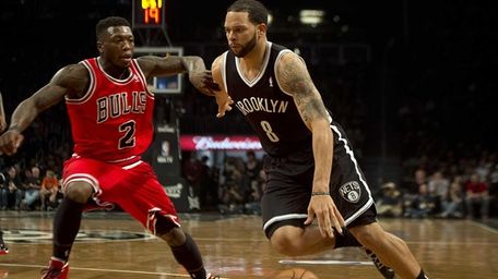 Deron Williams drives the baseline against the Chicago