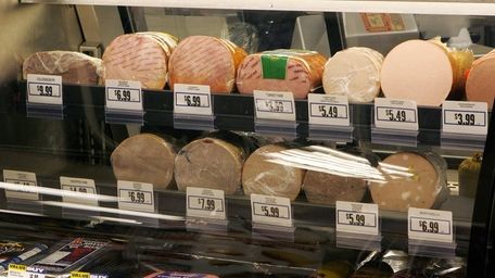 Meats are seen in a deli display at