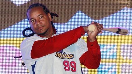 Former MLB star Manny Ramirez poses for media
