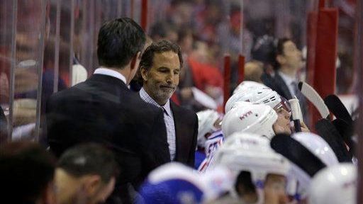 John Tortorella, right, stands in the bench area