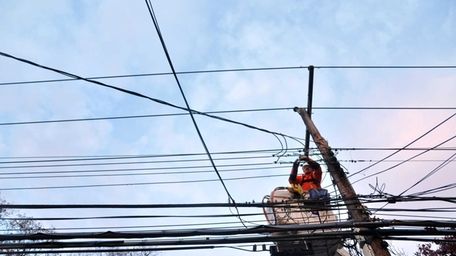 A LIPA subcontracted worker works on restoring power