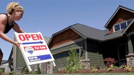 Realtor Sylvia Perry sets out an open sign