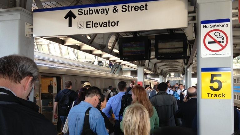 Commuters wait at Jamaica station in Queens for