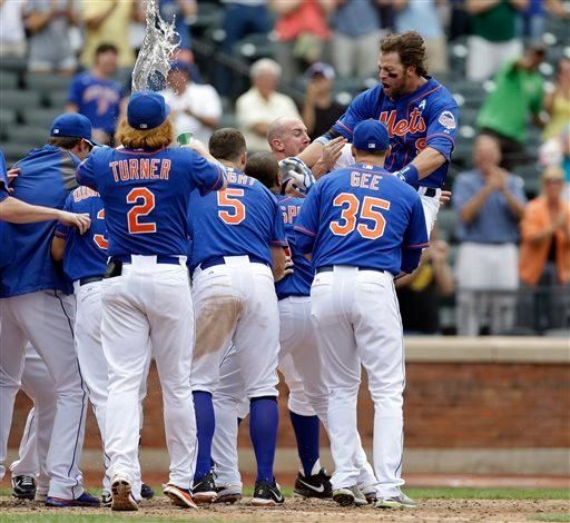 Kirk Nieuwenhuis dives into a throng of teammates