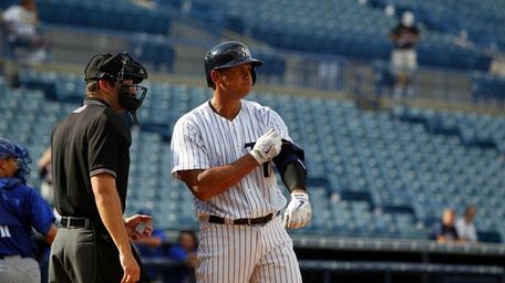 Alex Rodriguez takes off his equipment after striking