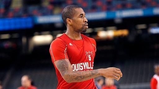 Louisville guard Chris Smith warms up during a