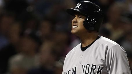 Yankees' Alex Rodriguez grimaces after fouling off a