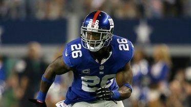 Antrel Rolle (26) sprints off the line of