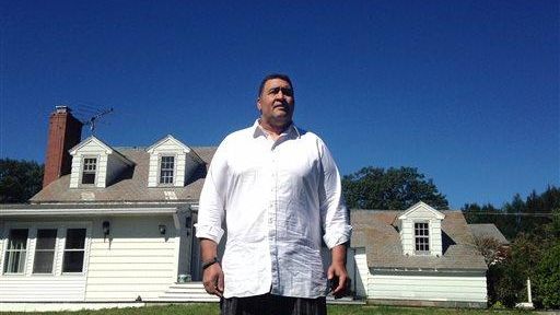 Former NFL offensive lineman Brian Holloway stands in