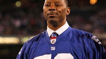 Carl Banks looks on during a ceremony before