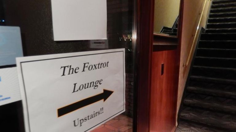 A sign points the way to the upstairs