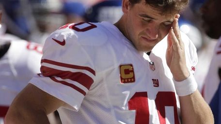 Giants quarterback Eli Manning stands on the sideline
