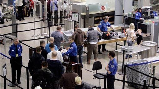 Airline passengers line up at the TSA security