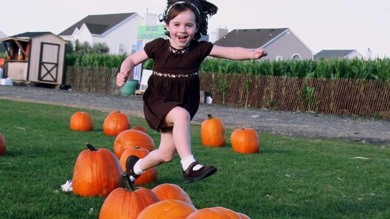 Erin Haggerty, 5, jumps for joy while picking