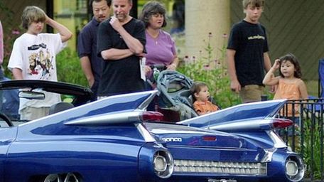 People look at a "Ronco", a Mazda Miata,