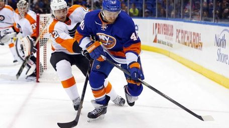 Michael Grabner of the Islanders tries to control
