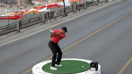 Tiger Woods takes a shot on the iconic