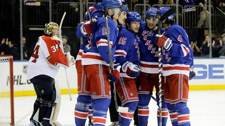 Derek Dorsett celebrates with teammates after he scored