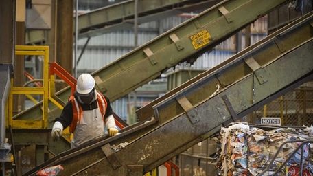 Employees sort recyclables on machines at Brookhaven Town's