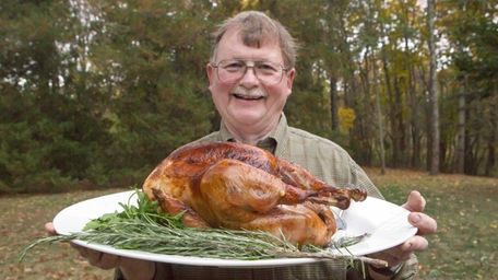 Chef John Ross holds a a slow-roasted, brined