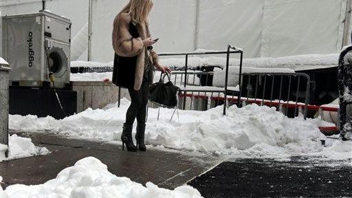 A woman checks her mobile phone outside Lincoln