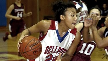 Bellport's Arella Guirantes drives into the paint against