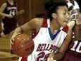 Bellport's Arella Guirantes drives into the paint against