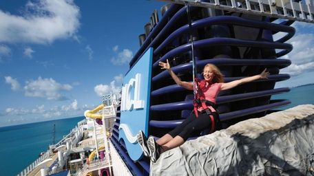 A passenger swings on the ropes course on
