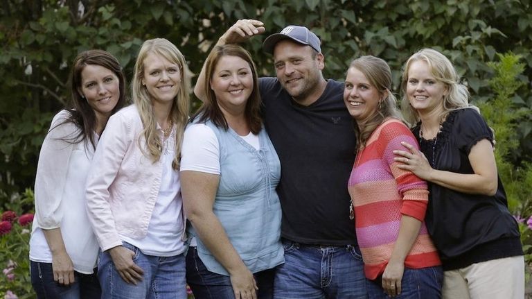 Brady Williams poses with his wives, from left