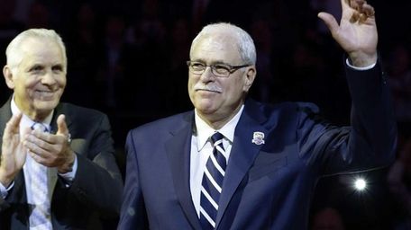Phil Jackson waves to the crowd as former