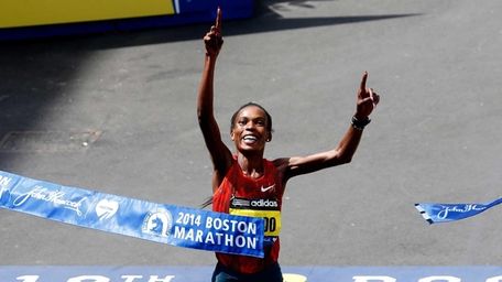 Rita Jeptoo of Kenya crosses the finish line