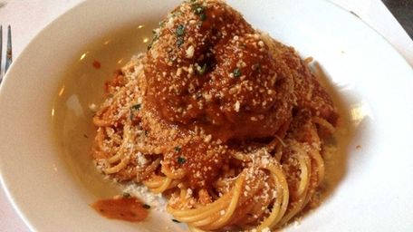 An order of spaghetti and meatballs is cheerfully